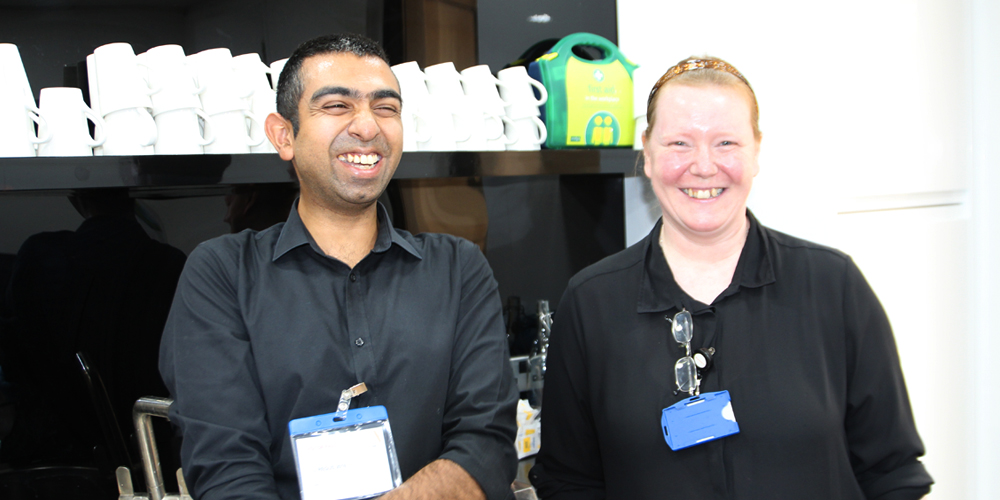 Man with learning disabilities at work with his colleague