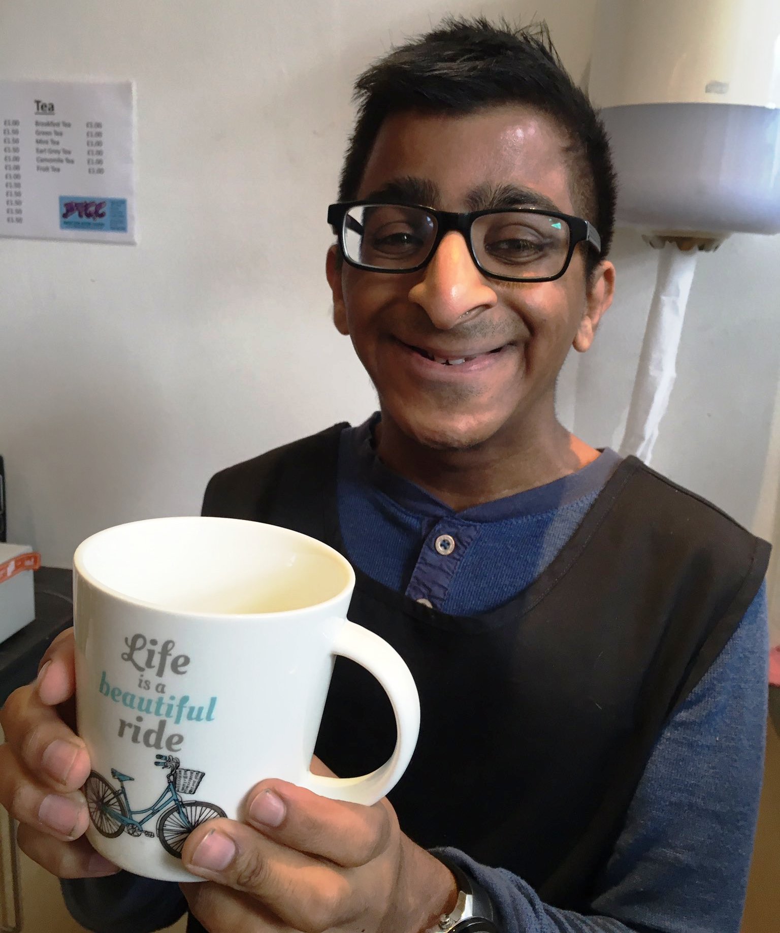 Young man holding a mug with a bike on it
