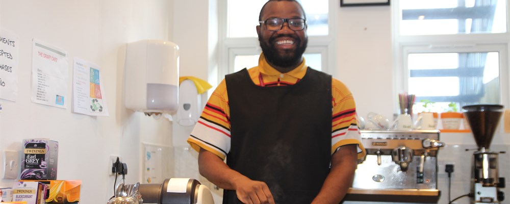 A learning disabled man working in a coffee shop