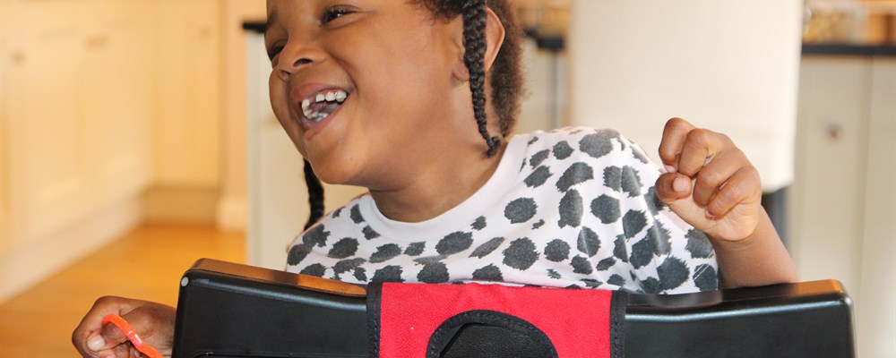 julia-message A young disabled girl in smiling in her powered wheelchair