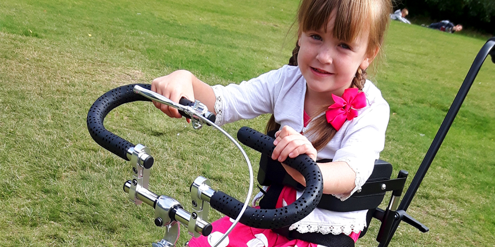 matilda new trike banner little girl on pink adapted trike
