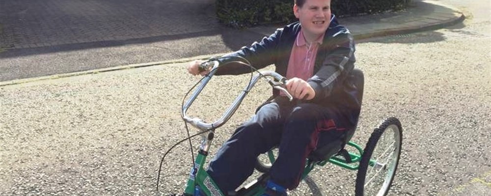 Teenager riding around in their trike