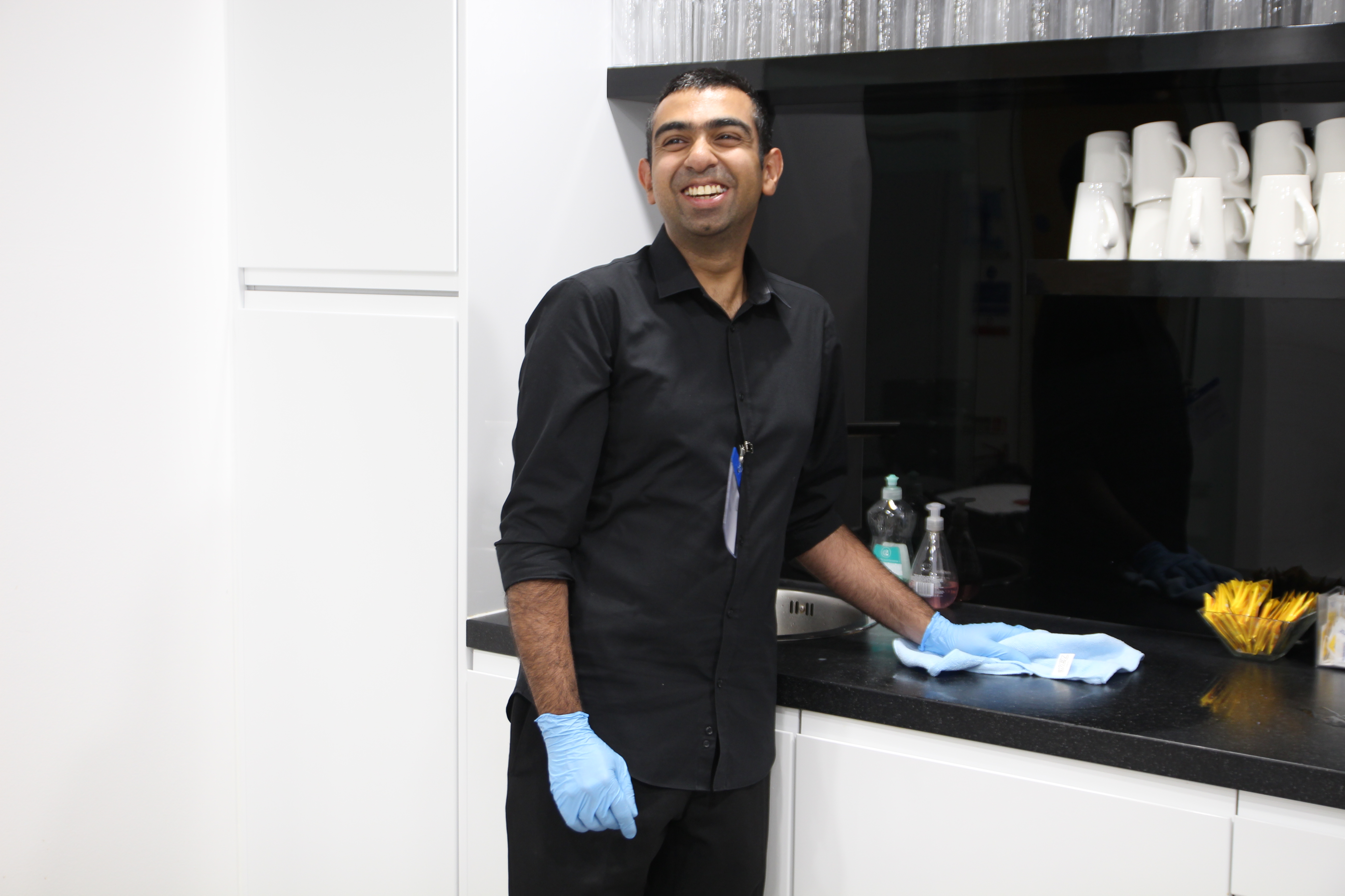 Young man cleaning a countertop