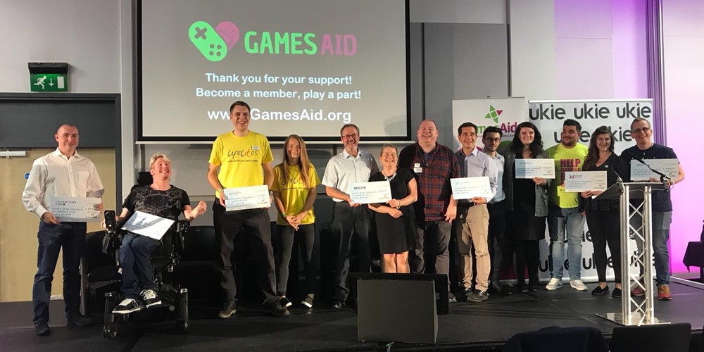my AFK Mobility Ambassador Jamie Green on stage with other charity recipients of GamesAid funding.