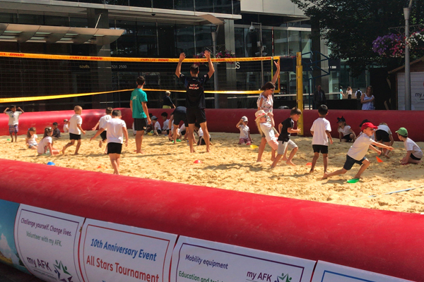 School kids on the beach volleyball court