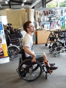 Jamie Green trying out his new wheelchair in the shop