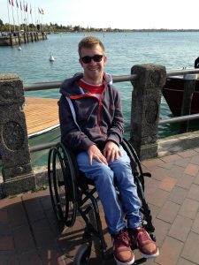 Jamie Green in his old wheelchair on a pier