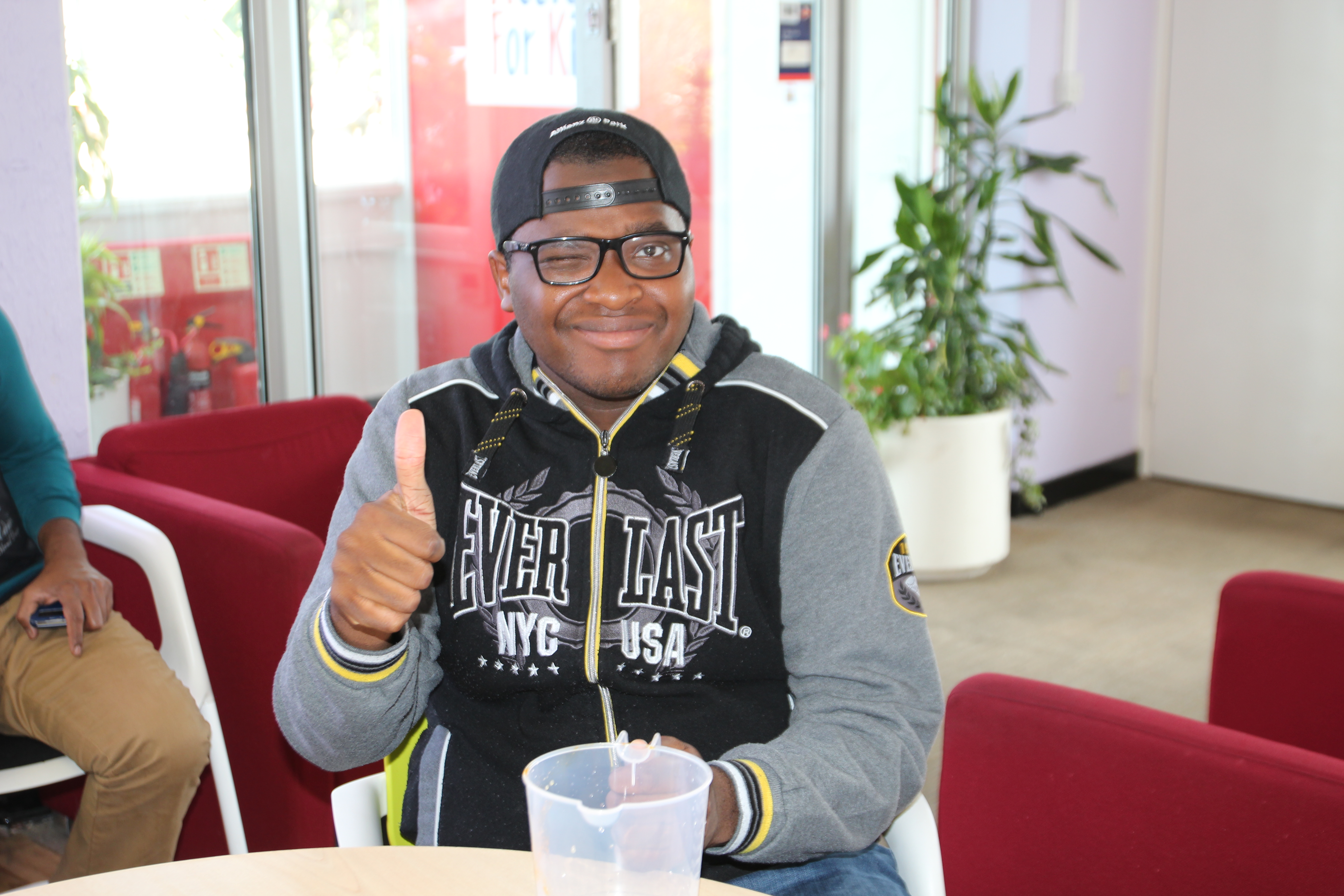 Young man giving a thumbs up and smiling