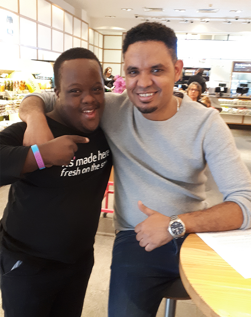 Nathan and his manager at Itsu A young man with Down Syndrome with his manager in an Itsu sushi resturant