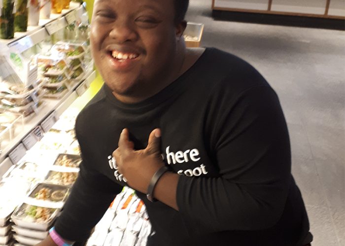 A young man with Down Syndrome working at an Itsu sushi restaurant