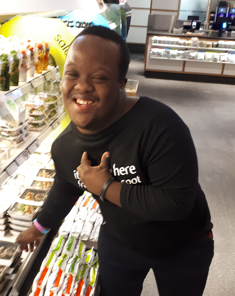 A young man with Down Syndrome working at an Itsu sushi restaurant