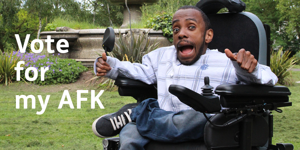 Man in a powered wheelchair with thumbs up