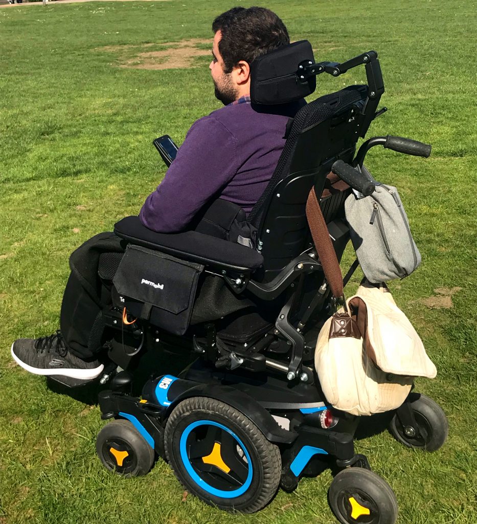 man in powerchair on grass