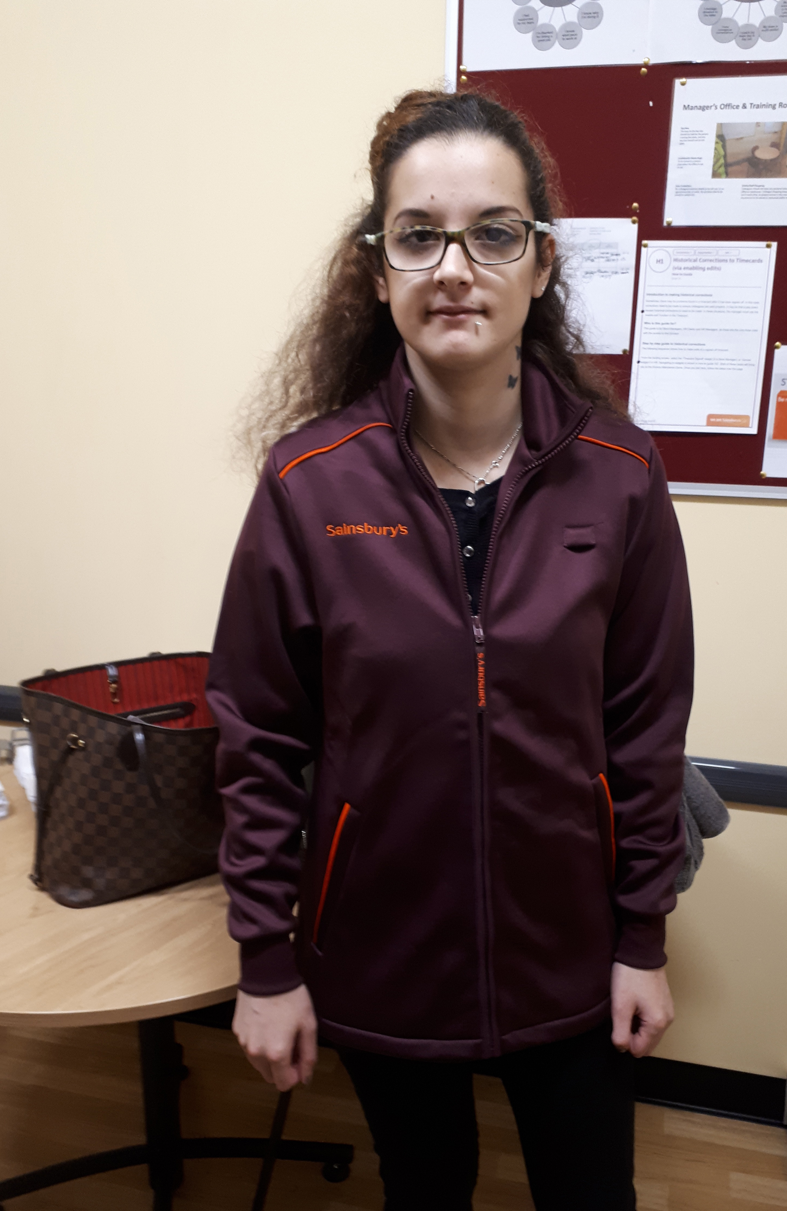 Young woman in a Sainsbury's uniform