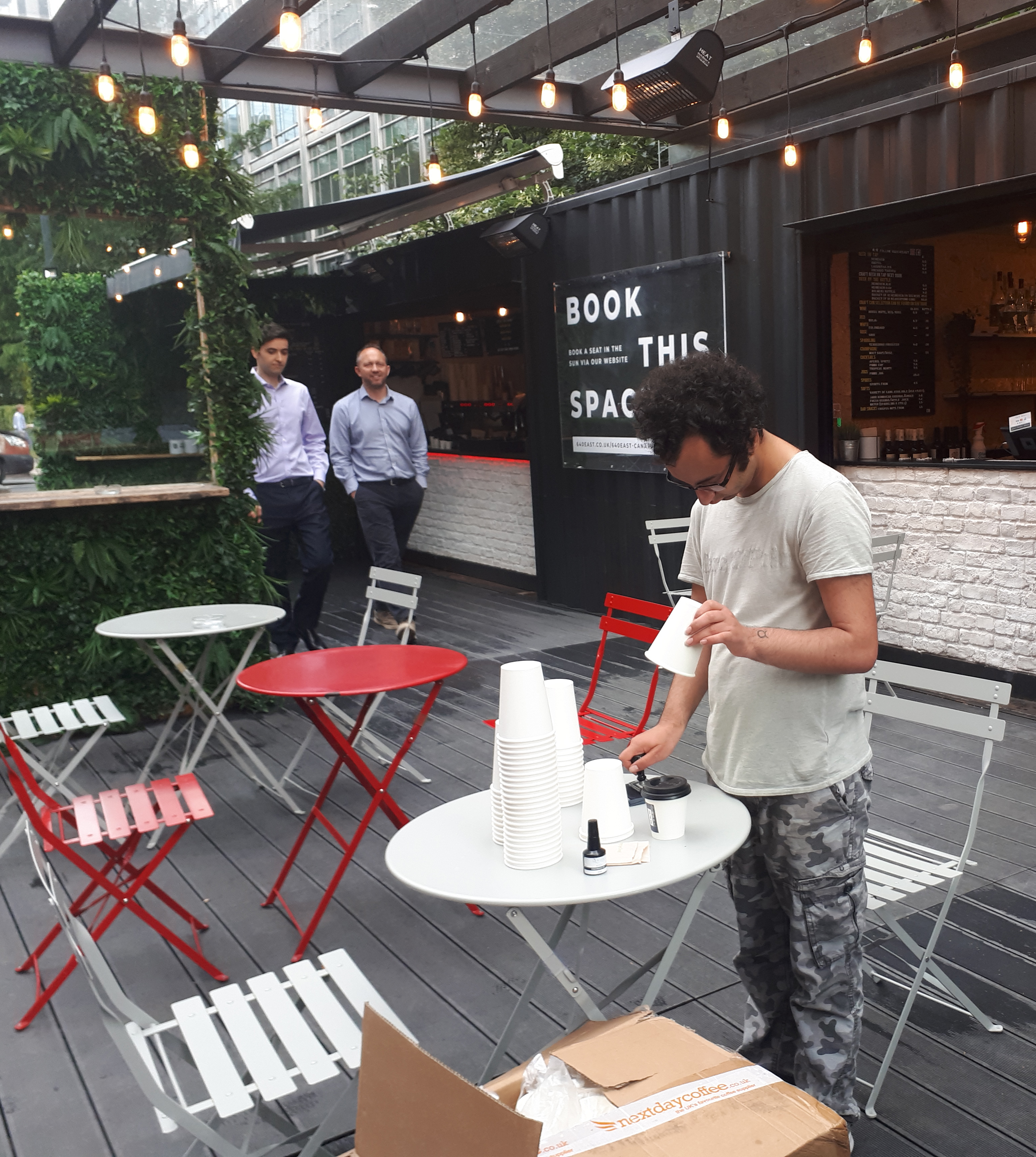 Joshua stamping coffee cups