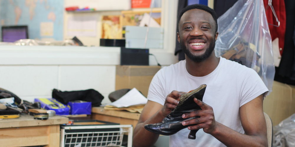 Kerone at work Kerone is looking at the camera smiling whilst shining shoes