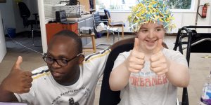holiday programme fun Two young people with learning disabilities giving thumbs up