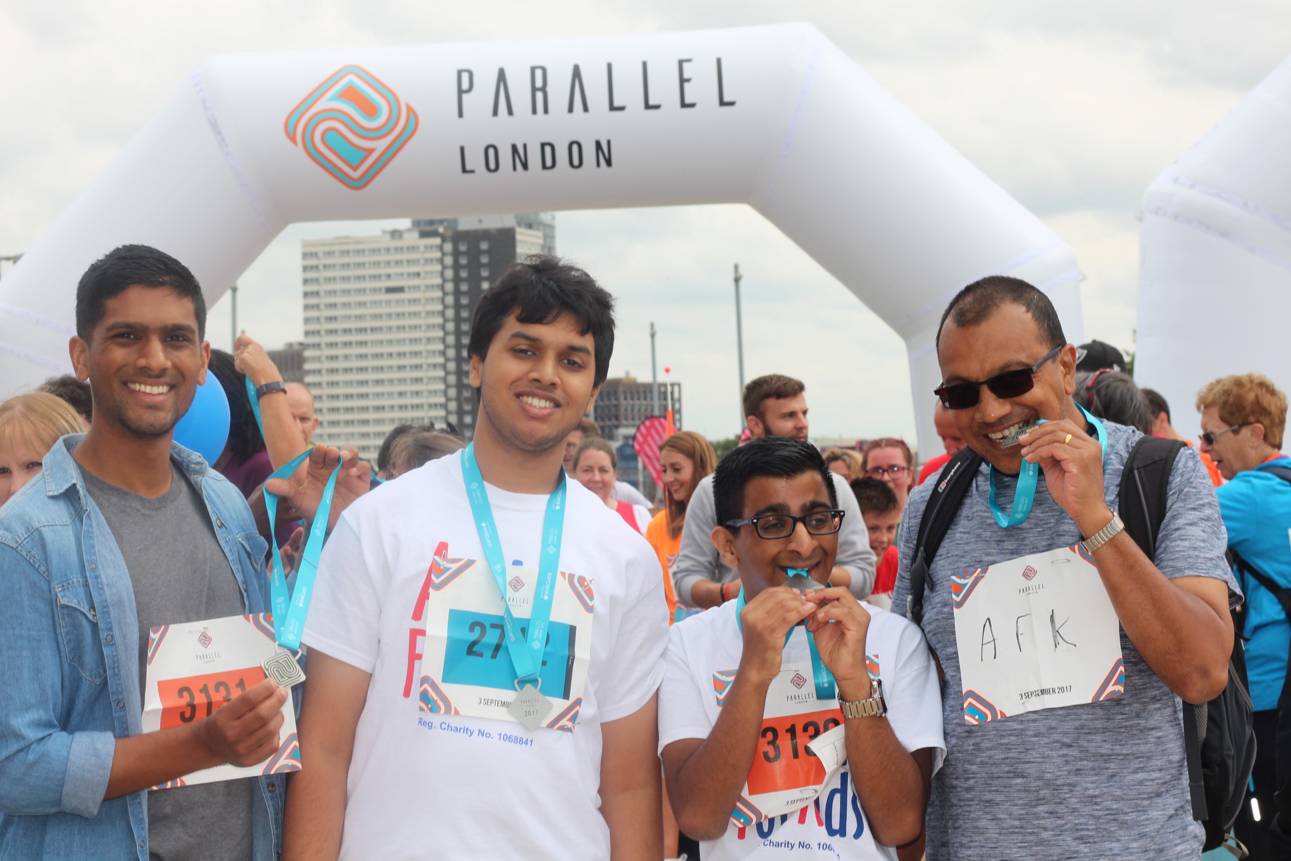 Group of young people at the Parallel London finish line with their medals