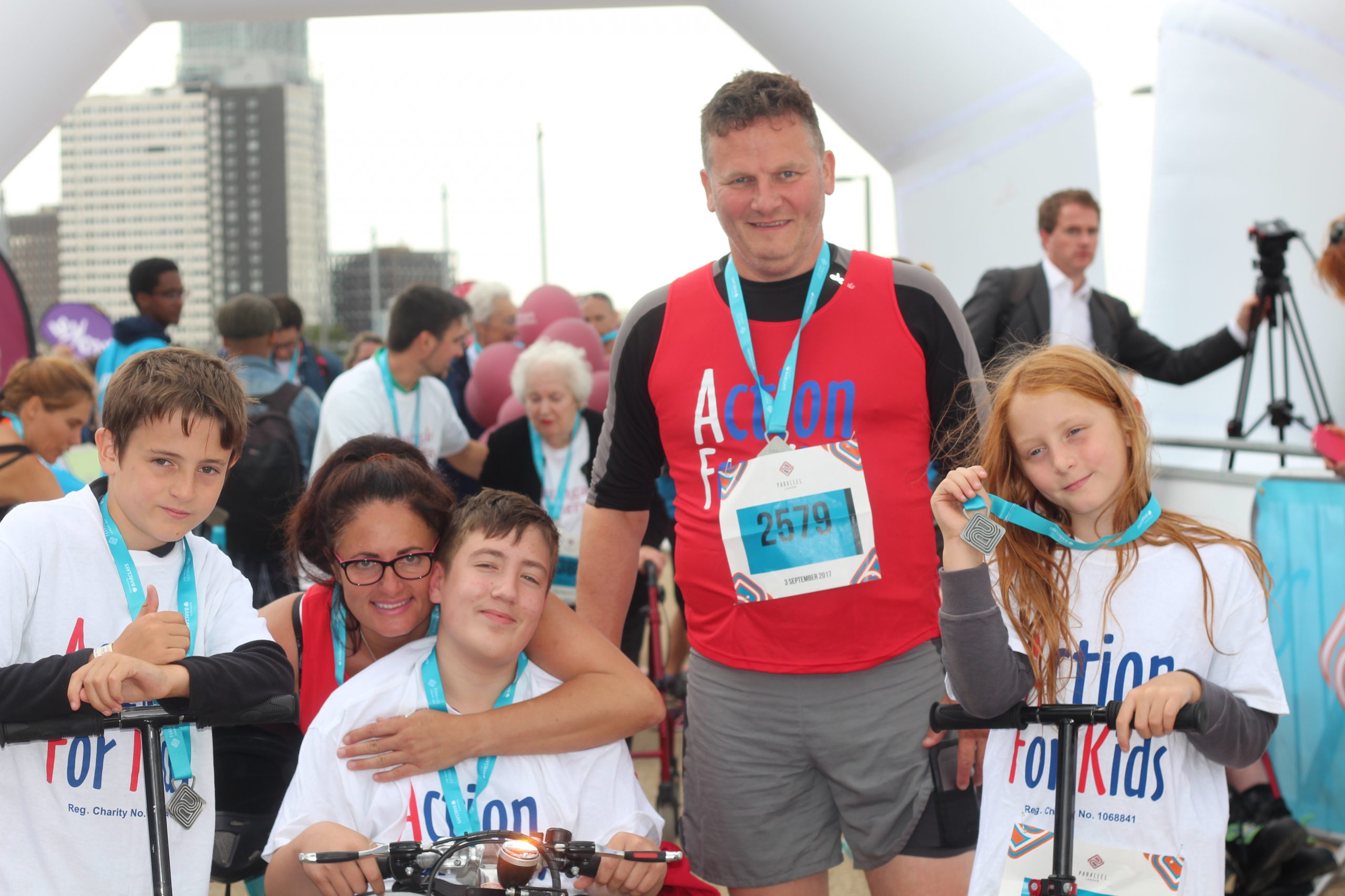 Group wearing AFK vests and medals at Parallel London finish line