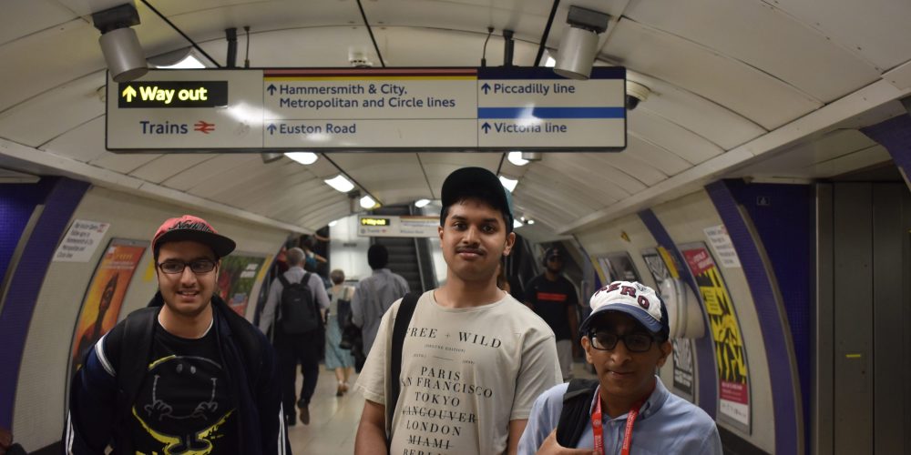 three young men navigating the london underground