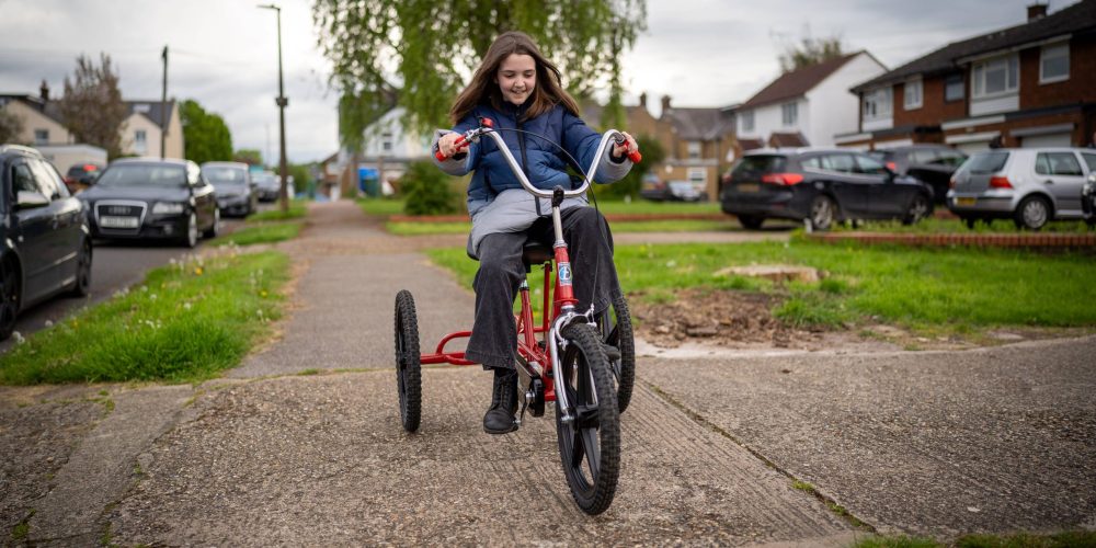 girl riding trike on pavement