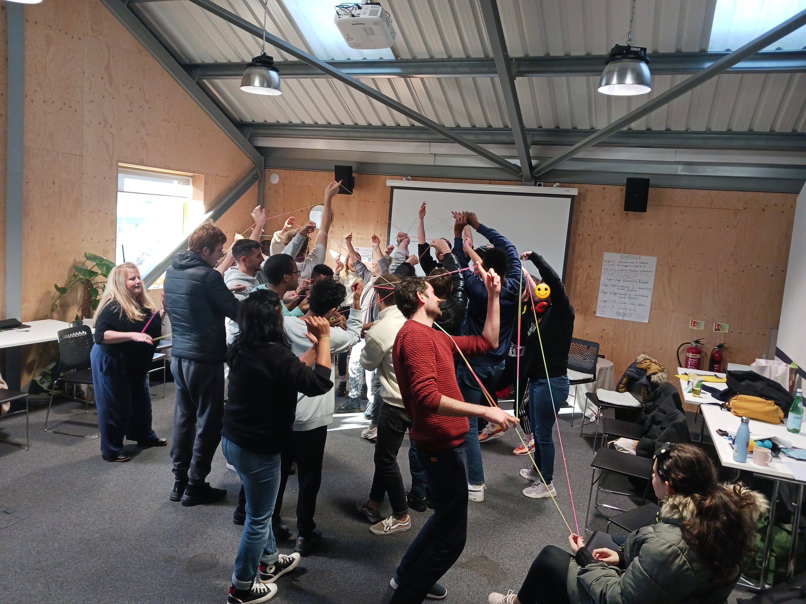 groupf of young people in a team building exercise collaborating and working together