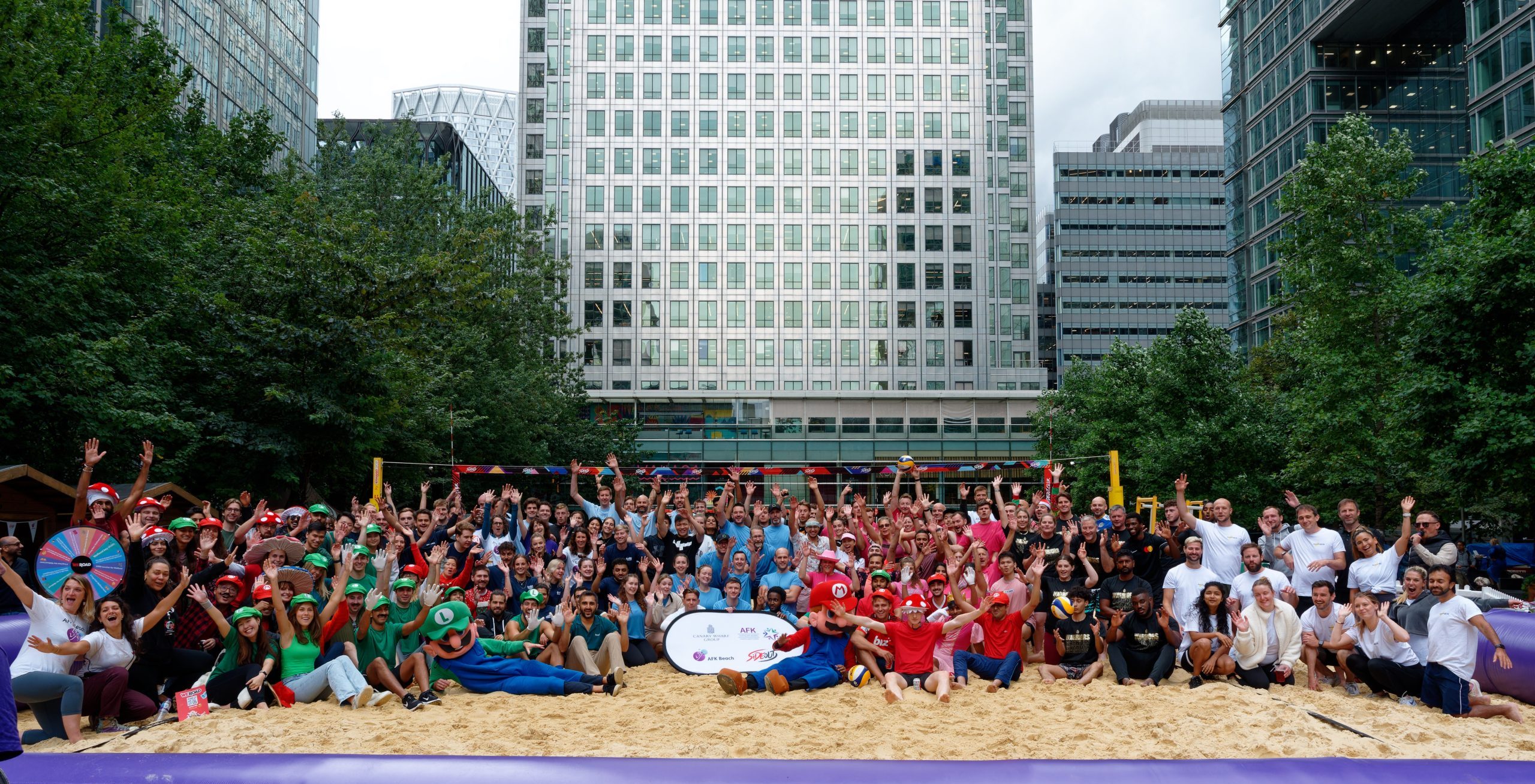 large group of beach volleyball players smiling