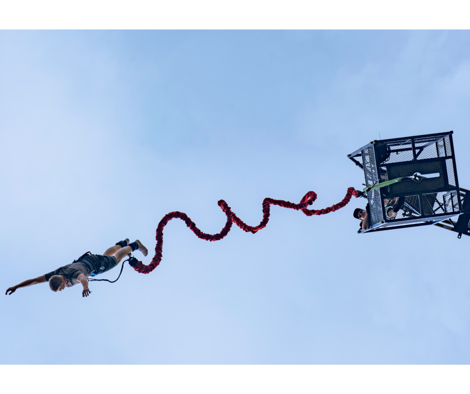 person bungee jumping from crane