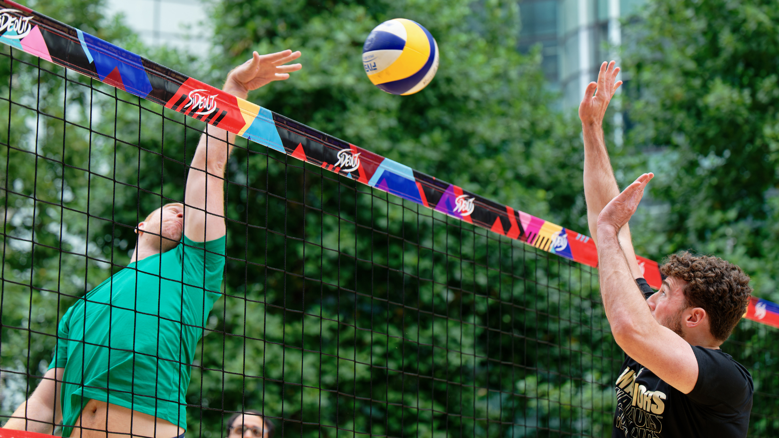 AFK Beach volleyball rally at the net Two players reach for the ball over the net during an AFK Beach volleyball match.